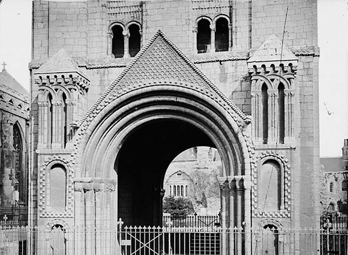 A Norman tower in Bury St Edmonds, in Suffolk, England, showing many of the typical features of Romanesque architecture, namely solid, massive construction, with small round-arched windows. The interlocking arches and the geometric patterns were very popular forms of architectural ornamentation.